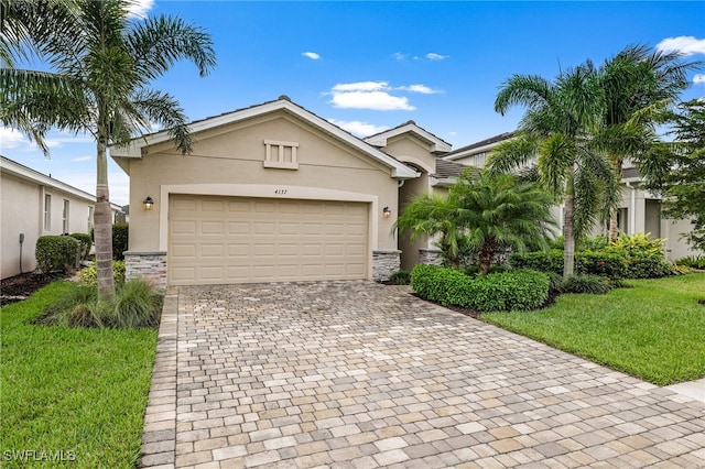 view of front of home featuring a garage and a front lawn