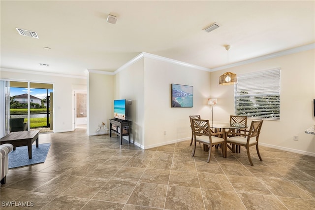 dining space with a healthy amount of sunlight and crown molding