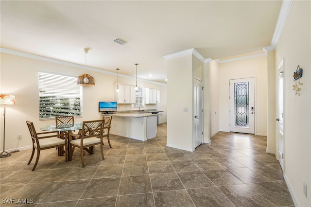 kitchen featuring sink, white cabinets, ornamental molding, kitchen peninsula, and hanging light fixtures