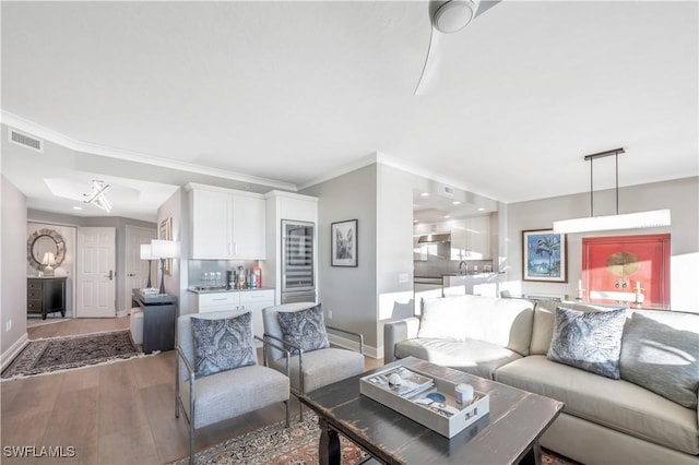 living room featuring hardwood / wood-style floors and crown molding