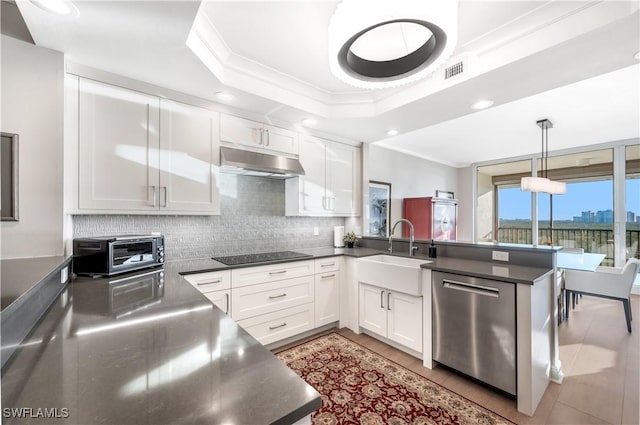 kitchen featuring sink, black electric cooktop, stainless steel dishwasher, pendant lighting, and white cabinets