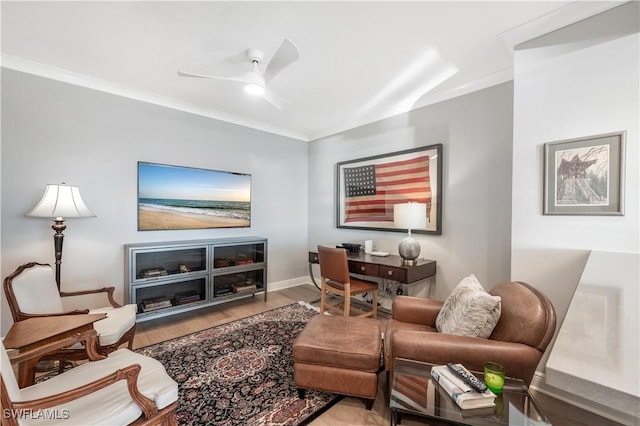 living room with crown molding, ceiling fan, and light hardwood / wood-style flooring