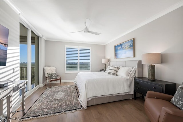 bedroom featuring hardwood / wood-style floors, ornamental molding, and ceiling fan