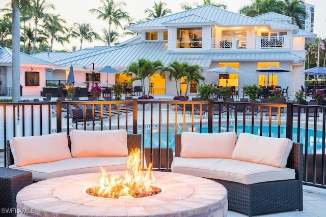 exterior space with a patio area and an outdoor living space with a fire pit