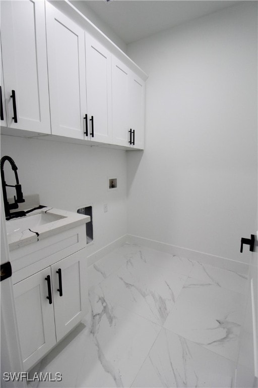 laundry room featuring cabinets, hookup for a washing machine, and sink