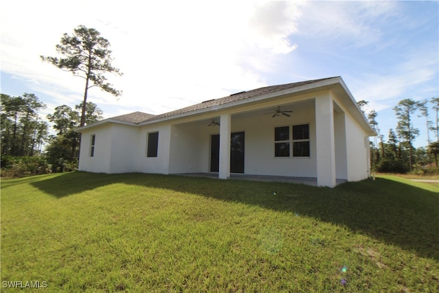 back of house featuring a lawn