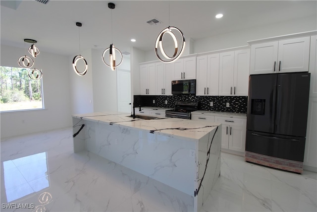 kitchen featuring pendant lighting, white cabinetry, and black appliances