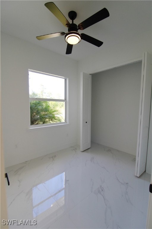 unfurnished bedroom featuring ceiling fan