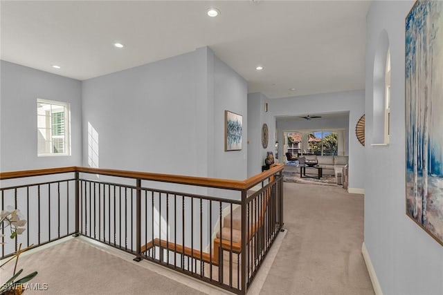 hallway featuring light colored carpet