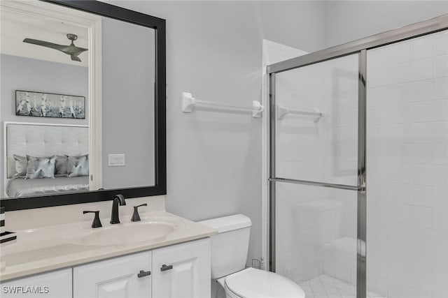 bathroom with a shower with door, toilet, and vanity