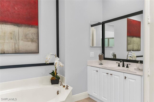 bathroom featuring vanity and a bathing tub