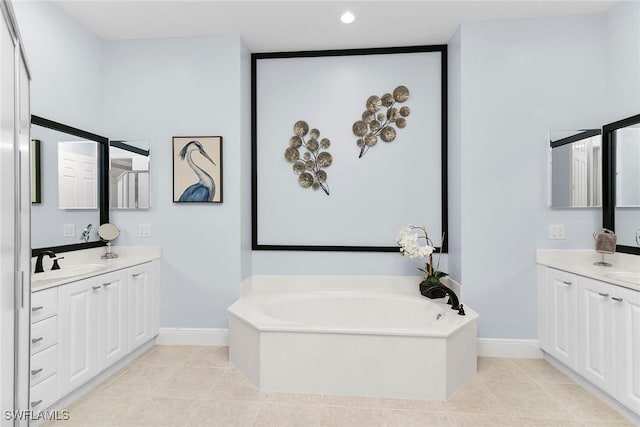 9219 Corfu Ct Unit 202, Naples, FL 34114 - bathroom with two vanities, a garden tub, tile patterned floors, and recessed lighting