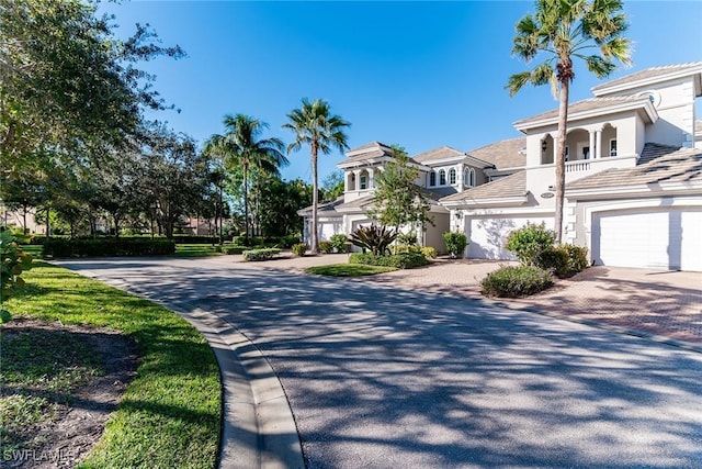 9219 Corfu Ct Unit 202, Naples, FL 34114 - view of front of home featuring decorative driveway, stucco siding, and an attached garage