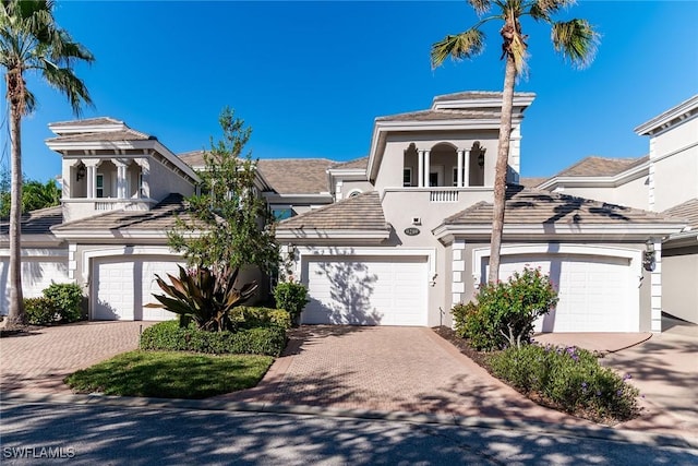 9219 Corfu Ct Unit 202, Naples, FL 34114 - view of front of house with decorative driveway, a balcony, and stucco siding