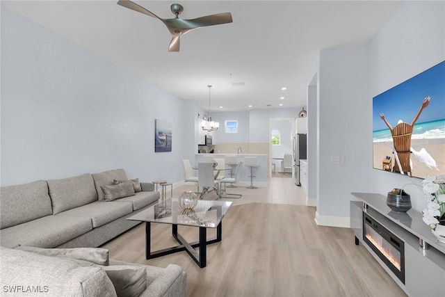 9219 Corfu Ct Unit 202, Naples, FL 34114 - living area with light wood-style floors, a ceiling fan, a chandelier, and recessed lighting