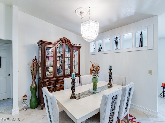 tiled dining area with a chandelier