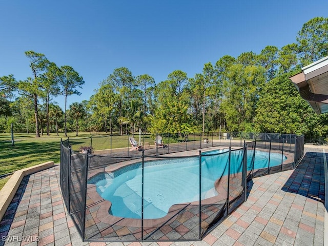 view of pool featuring a lawn