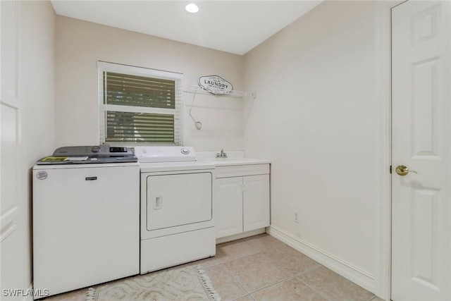 laundry room with cabinets, sink, separate washer and dryer, and light tile patterned flooring