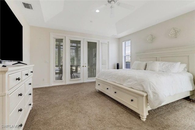 bedroom featuring access to outside, a raised ceiling, ceiling fan, and light colored carpet