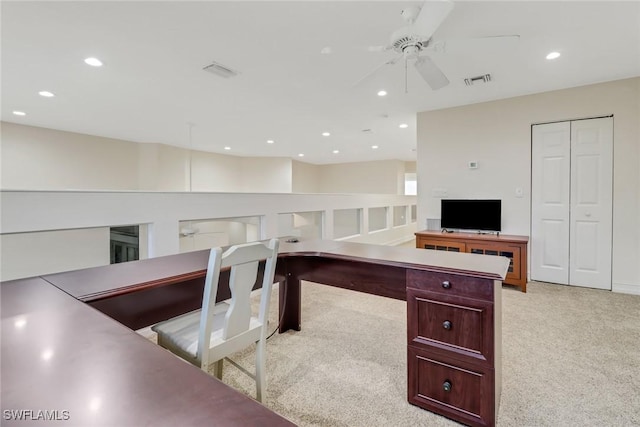 carpeted home office with ceiling fan