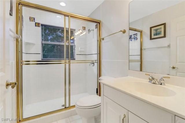 bathroom with tile patterned flooring, vanity, toilet, and a shower with door