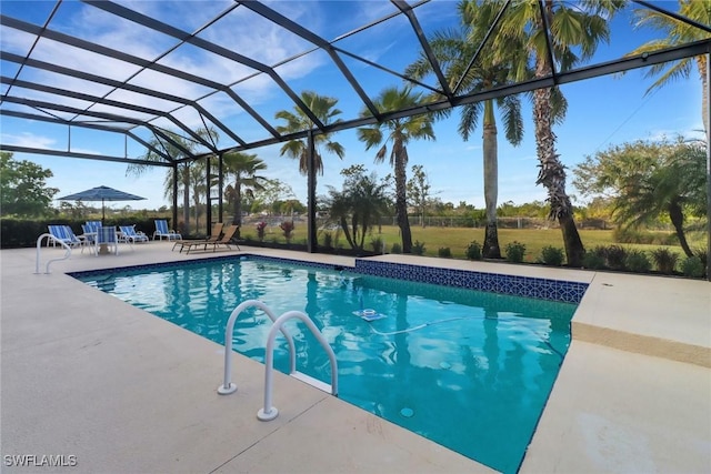 view of pool with glass enclosure and a patio area