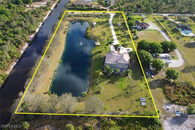 birds eye view of property with a water view