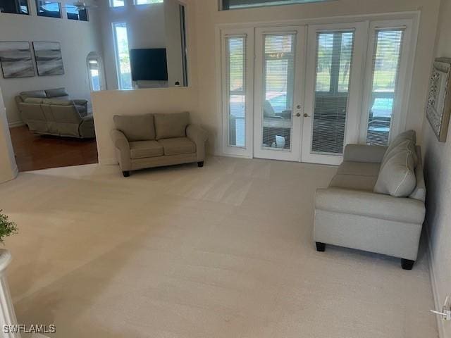 living room with french doors and carpet