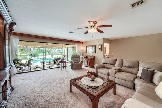 living room featuring light colored carpet and ceiling fan