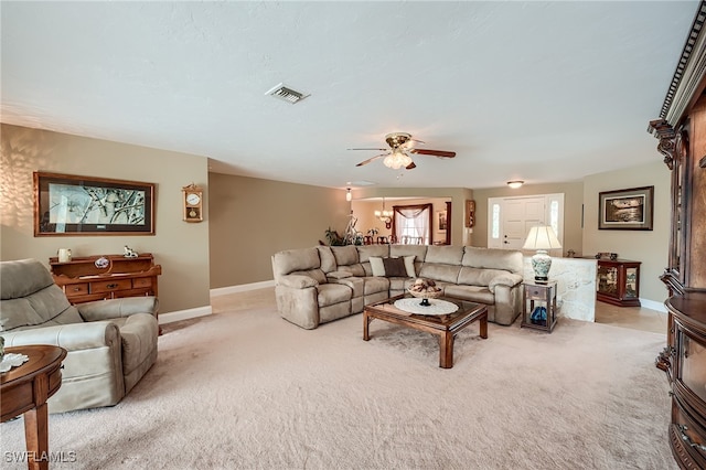 living room with ceiling fan and light colored carpet