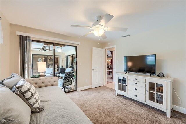 carpeted living room with ceiling fan