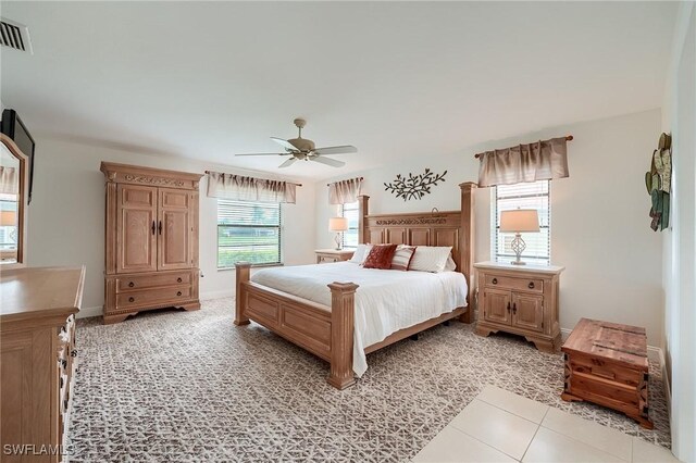 bedroom with ceiling fan and light tile patterned floors