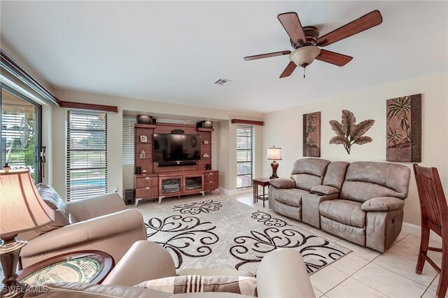 living room featuring light tile patterned floors and ceiling fan