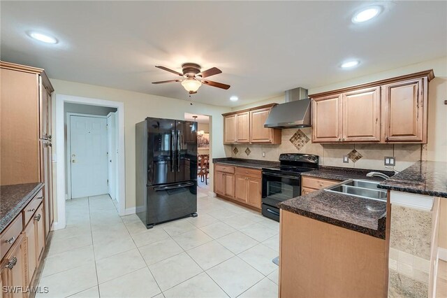 kitchen with black appliances, sink, wall chimney exhaust hood, ceiling fan, and light tile patterned floors