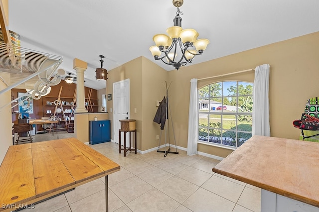 tiled dining room with ceiling fan with notable chandelier