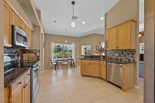 kitchen with visible vents, appliances with stainless steel finishes, light brown cabinetry, dark stone countertops, and pendant lighting