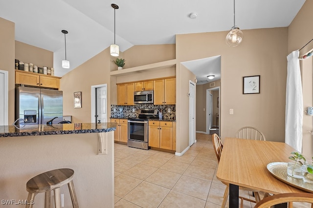 kitchen with appliances with stainless steel finishes, backsplash, pendant lighting, and light brown cabinets