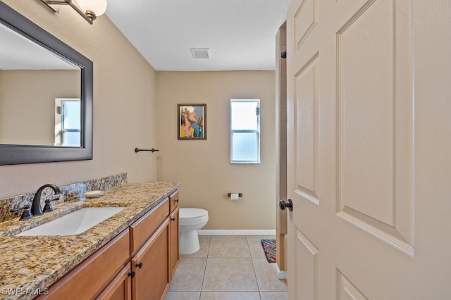 bathroom with tile patterned flooring, vanity, and toilet