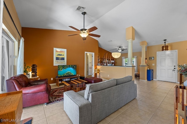 tiled living room featuring decorative columns, vaulted ceiling, and ceiling fan