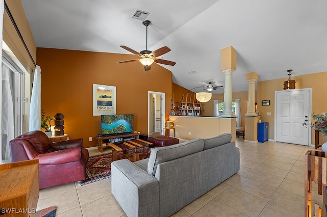 living room with ornate columns, ceiling fan, light tile patterned floors, and vaulted ceiling