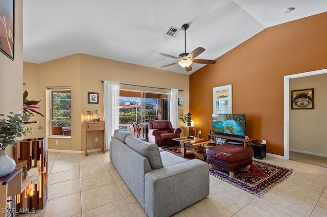 tiled living room featuring ceiling fan and lofted ceiling