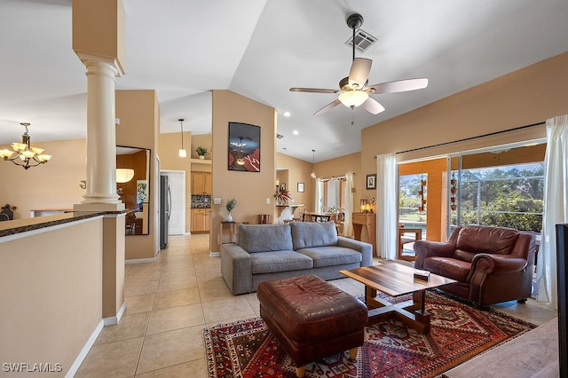 living room with ceiling fan with notable chandelier, decorative columns, vaulted ceiling, and light tile patterned flooring