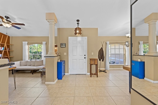 tiled foyer with ornate columns and ceiling fan