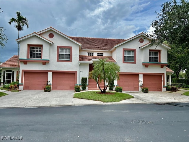 mediterranean / spanish home with a garage