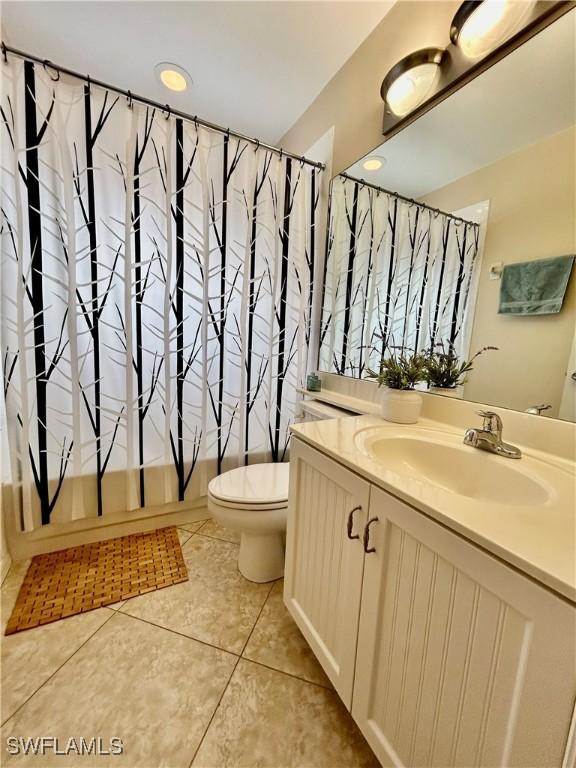 full bathroom featuring tile patterned flooring, vanity, shower / bath combo, and toilet