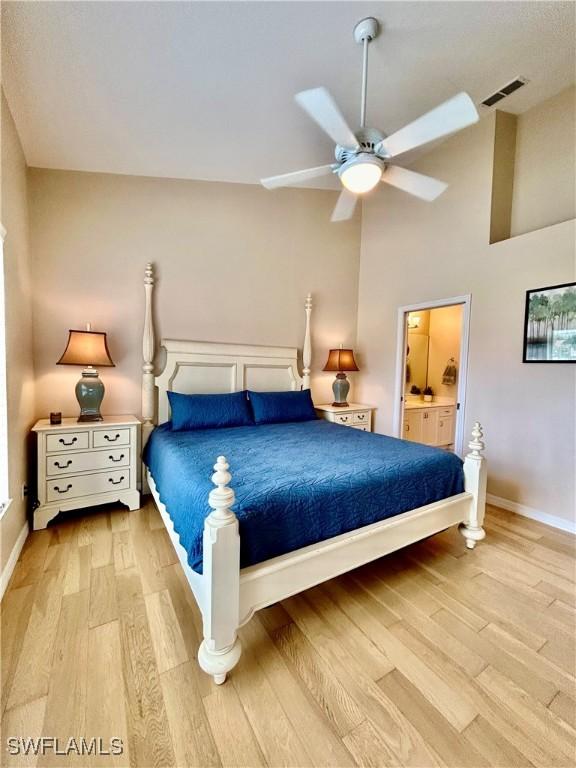 bedroom featuring light hardwood / wood-style floors, ceiling fan, and lofted ceiling