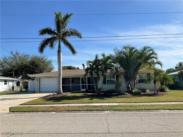 view of front of property with a garage and a front lawn