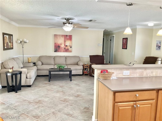 kitchen featuring pendant lighting, crown molding, a textured ceiling, and ceiling fan