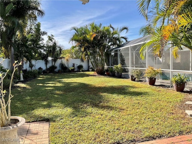 view of yard featuring a fenced in pool and a lanai