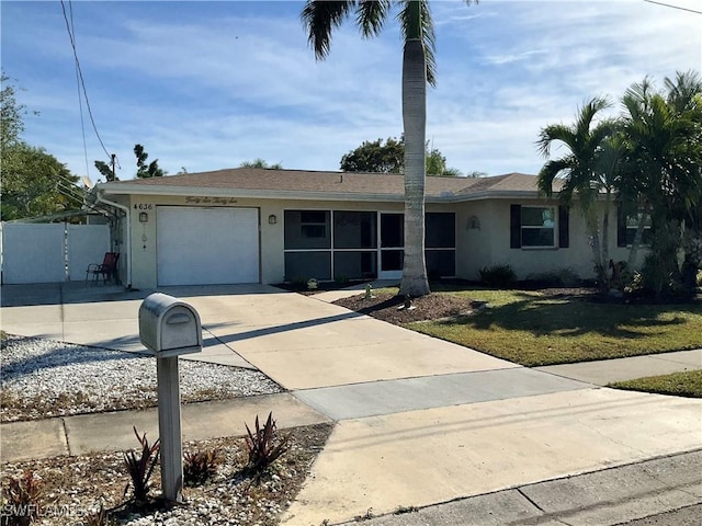 single story home featuring a garage and a front yard